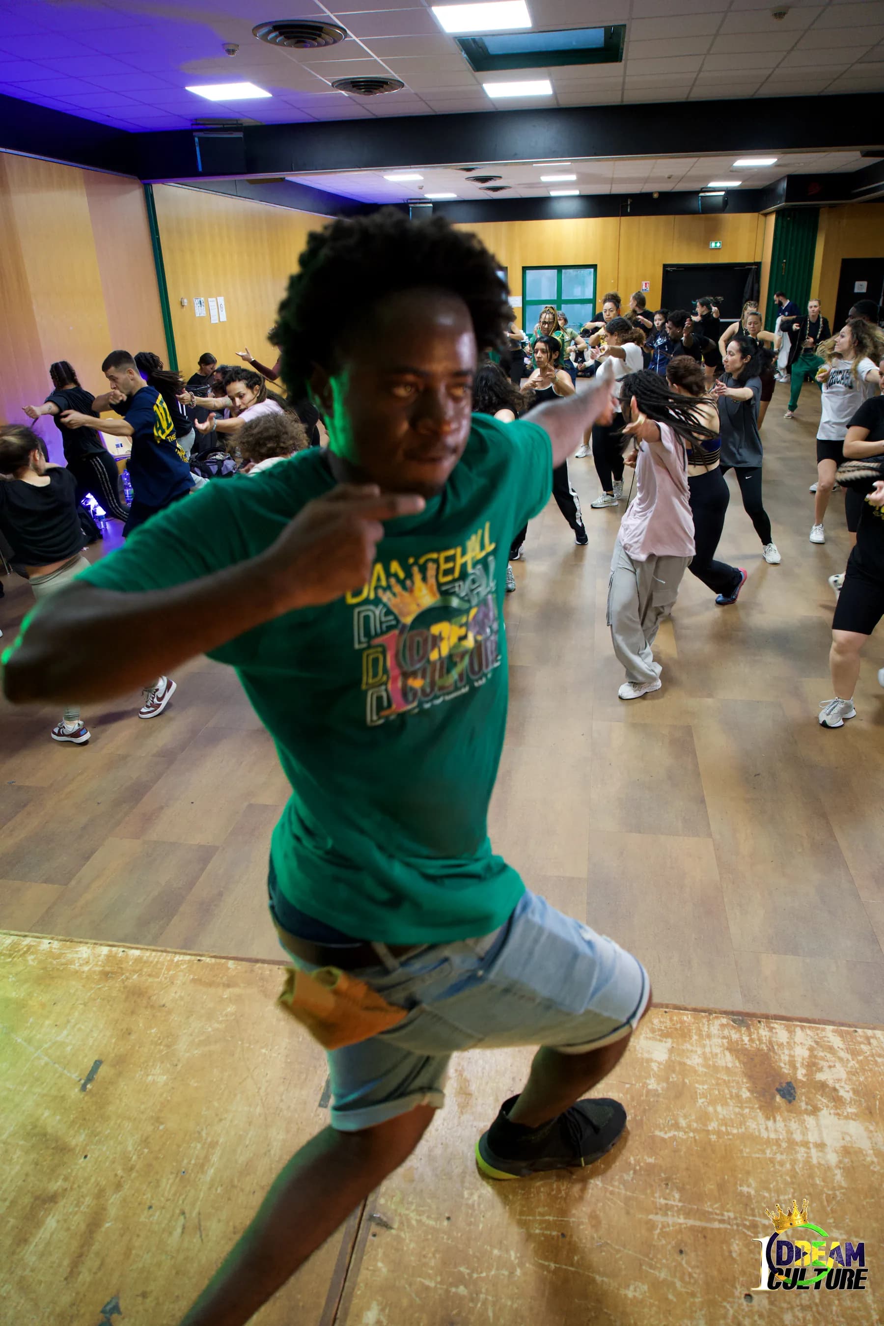 Kriptic leading a Dancehall class, a full studio moving behind him